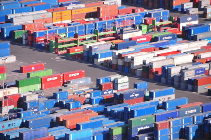 Shipping containers at a busy port, symbolizing logistics and inventory management.